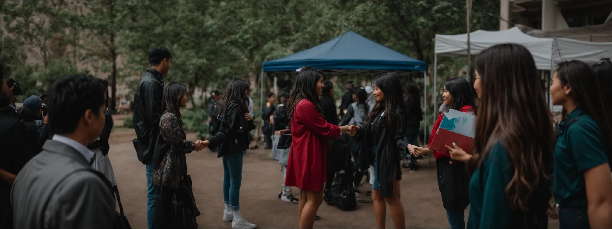 an influencer and a non-profit representative shaking hands at a collaborative event.
