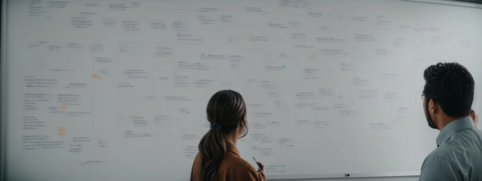 a business team reviewing a large visual seo strategy flowchart on a whiteboard.