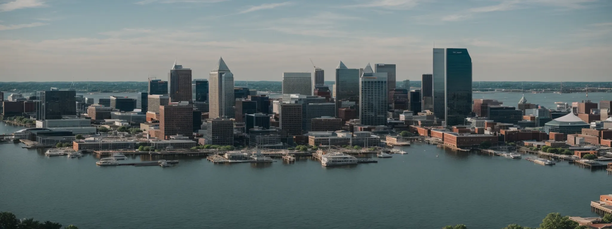 a panoramic view of downtown baltimore's skyline transitioning to the calm waters of the chesapeake bay.