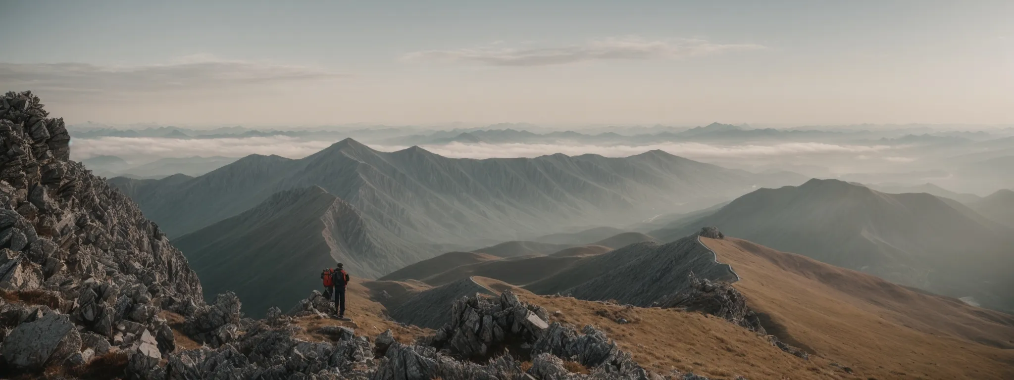 a person adjusting a sign atop a pristine peak with panoramic views, symbolizing the pinnacle of seo mastery.