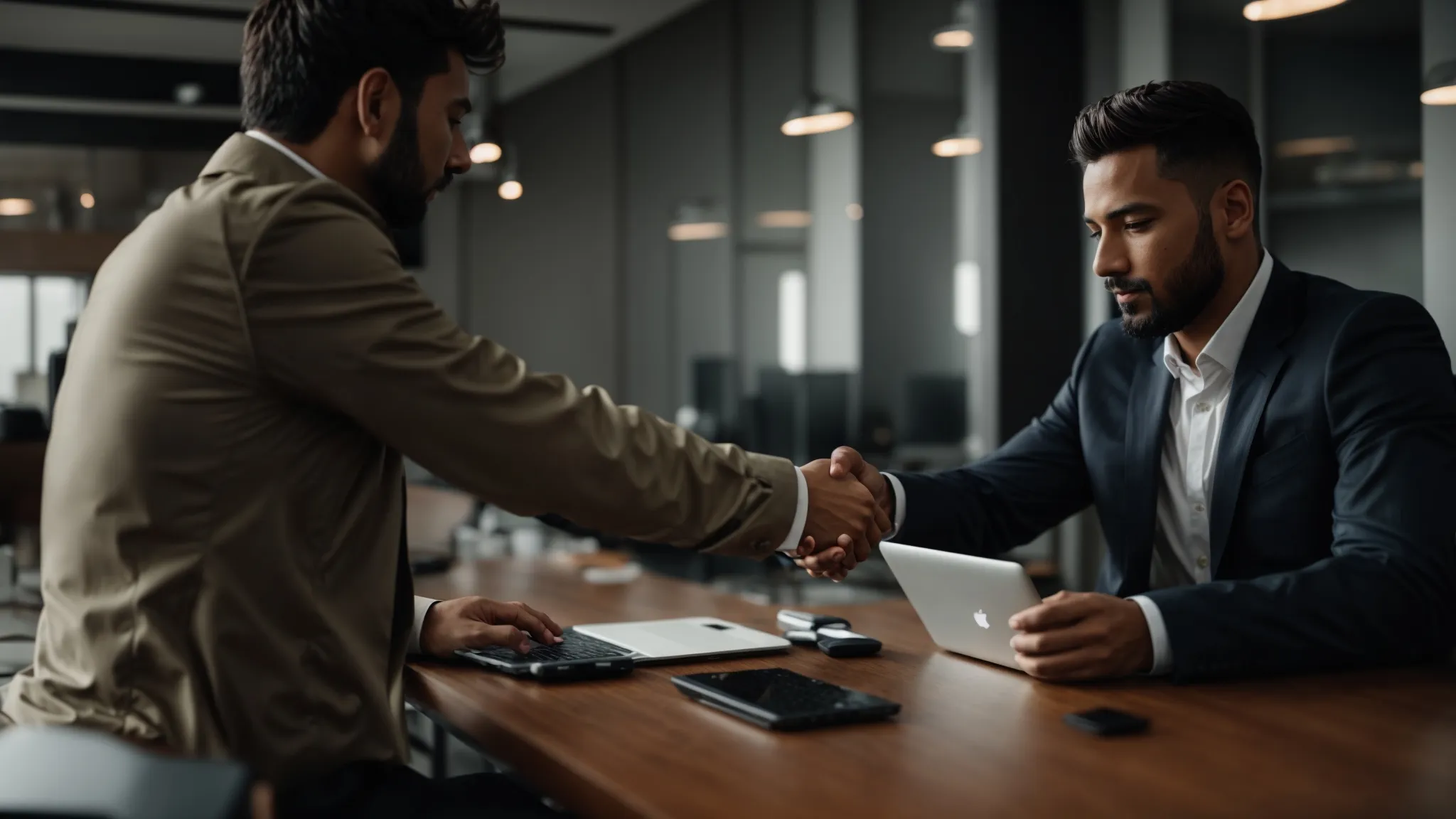 a confident business person is shaking hands with a partner in front of a laptop displaying analytics.