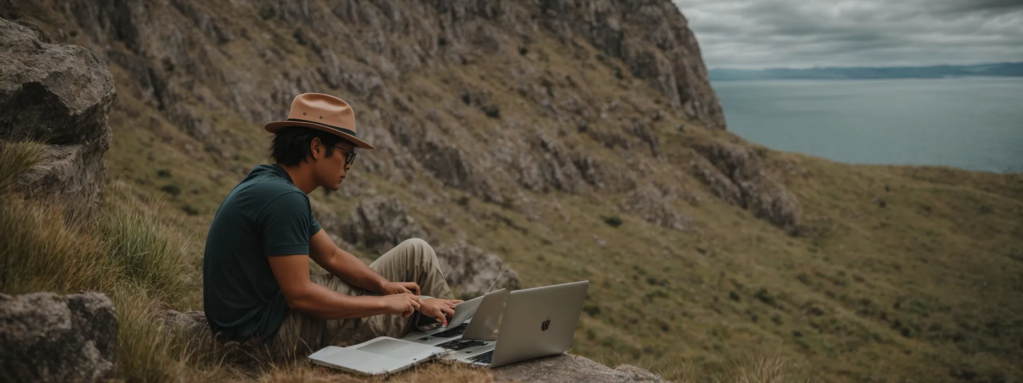 a travel blogger optimizing their destination website on a laptop amidst picturesque scenery.