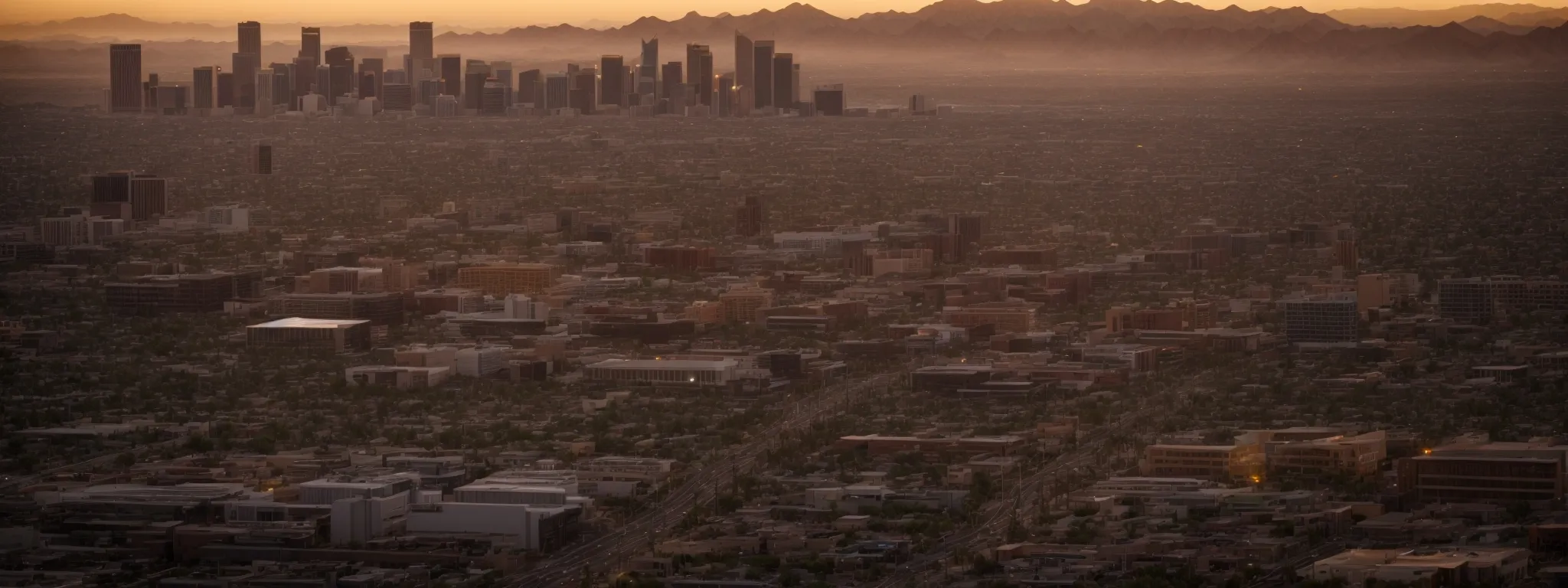 a wide cityscape of phoenix basked in a golden sunset.