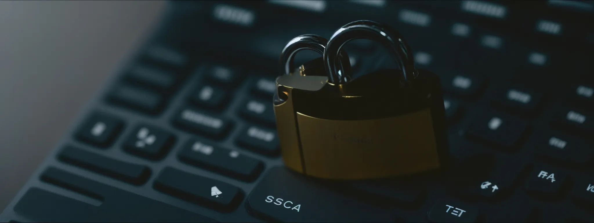 a padlock rests on top of a computer keyboard, symbolizing data security in the digital age.