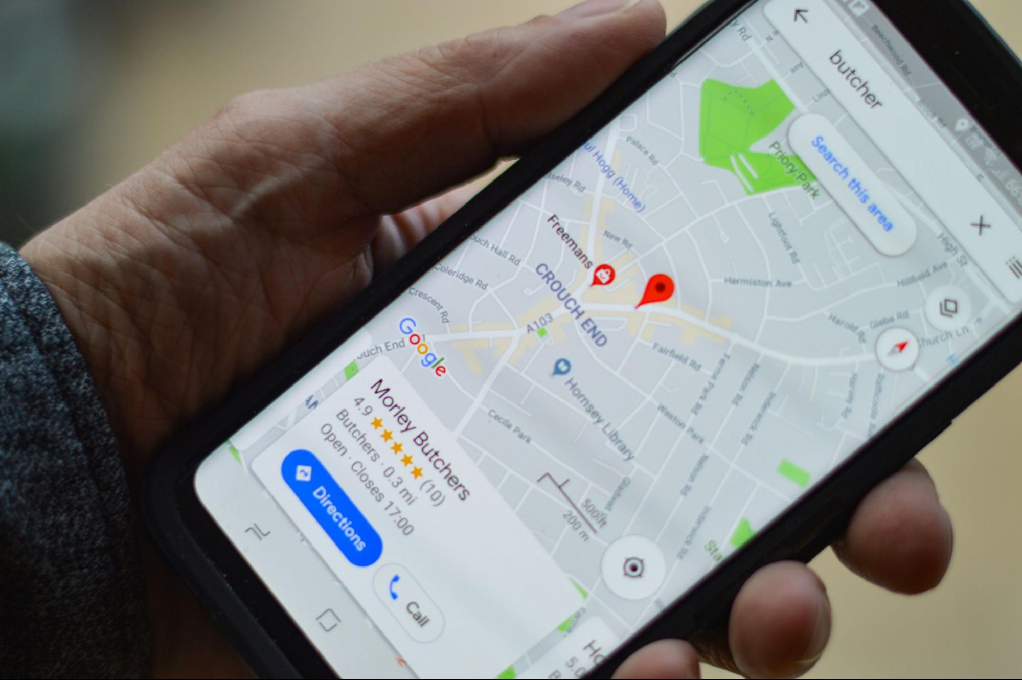 A smartphone displaying Google Maps with local search results, highlighting the importance of local SEO for photographers and how GBP optimization can enhance visibility