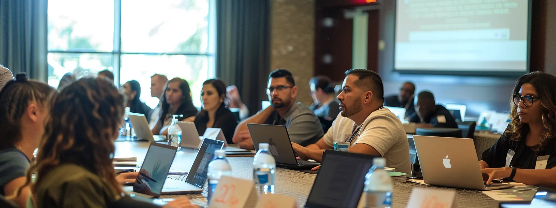 a diverse group of seo team members engaged in hands-on training, analyzing keyword data on laptops in a brightly lit conference room.