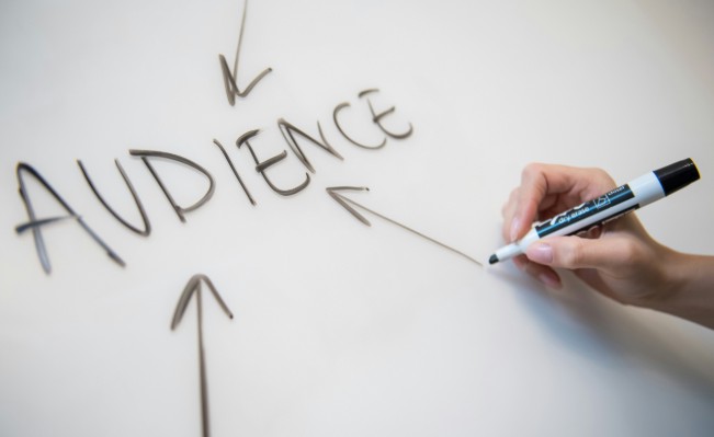  A person writes the word “audience” when talking about SEO terminology